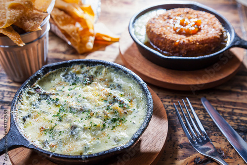 Artichoke, spinach, and cheese dip with breaded camembert cheese wheel horizontal