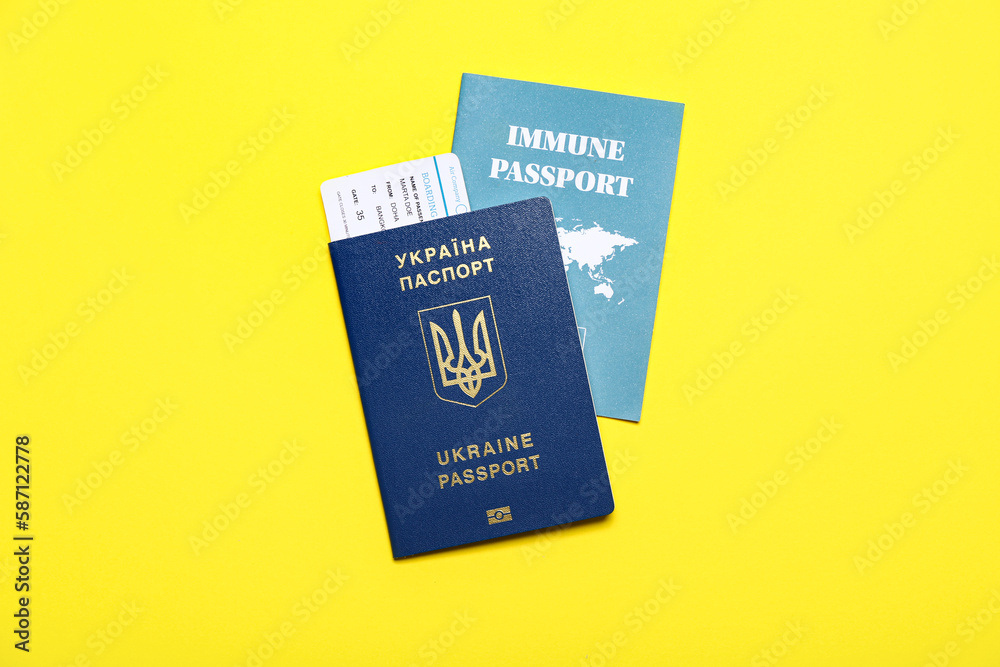 Ukrainian and immune passports on yellow background Ukrainian and immune passports on yellow background