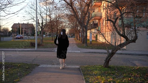 Tall beautiful young girl crossing the streets in the winter
