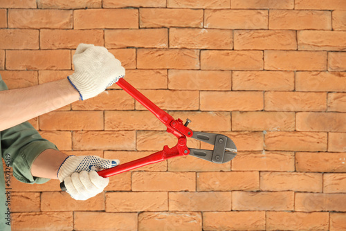 Worker with bolt cutter on ...