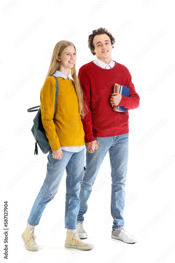 Teenage couple with books holding hands on white background Teenage couple with books holding hands on white background