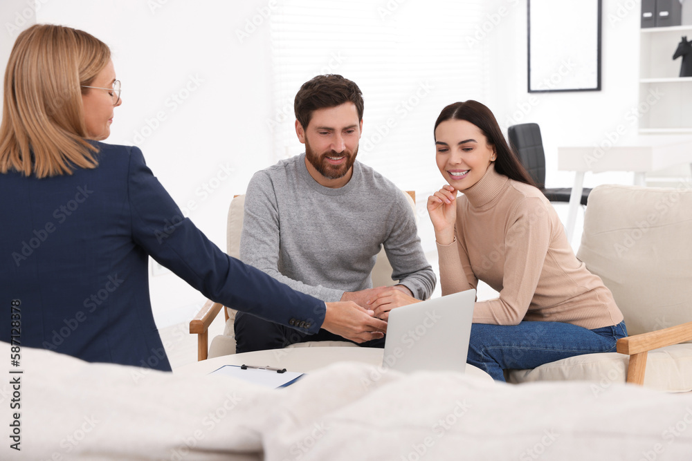 Real estate agent consulting couple in office Real estate agent consulting couple in office