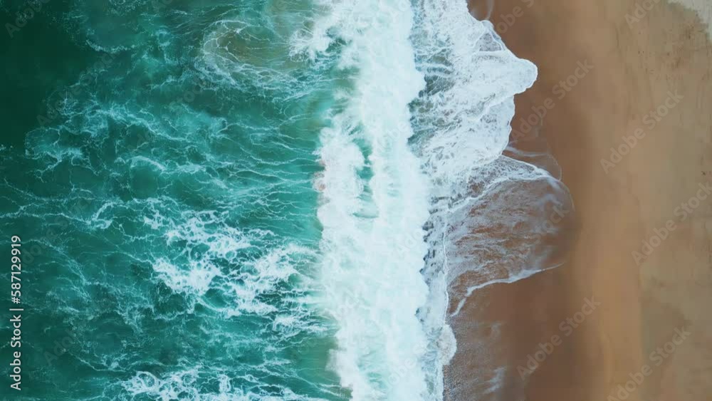 Top view blue sea waves washing beach. Aerial foamy water rolling on sandy coast