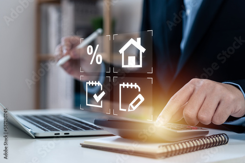 Businessman touching calculator for home loan concept, performance assessment and property value, contracts and percentage icons, loan amount, interest rate, loan term, mortgage, electronic signature.