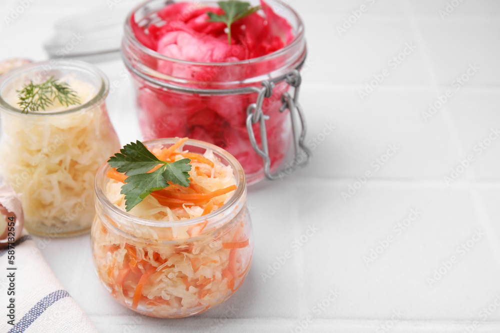 Delicious sauerkraut prepared according to different recipes on white table, closeup. Space for text Delicious sauerkraut prepared according to different recipes on white table, closeup. Space for text