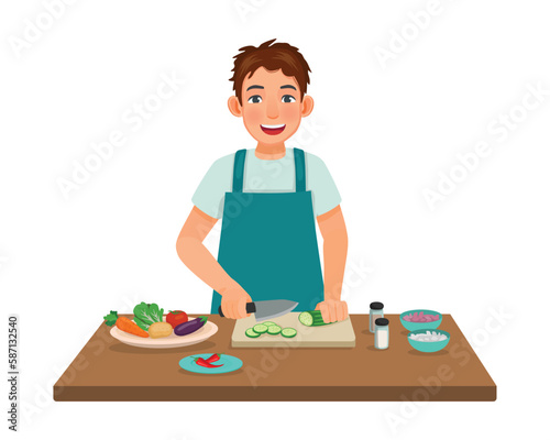 Young man cooking meal cutting slicing cucumber vegetable with knife in the kitchen