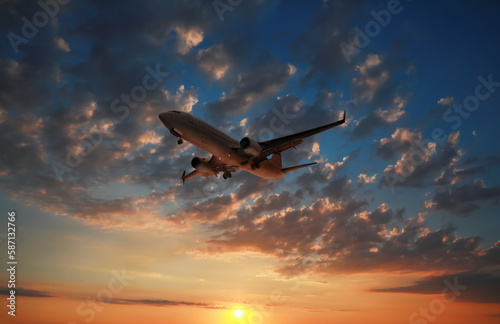 Plane in sky during sunset, low angle view