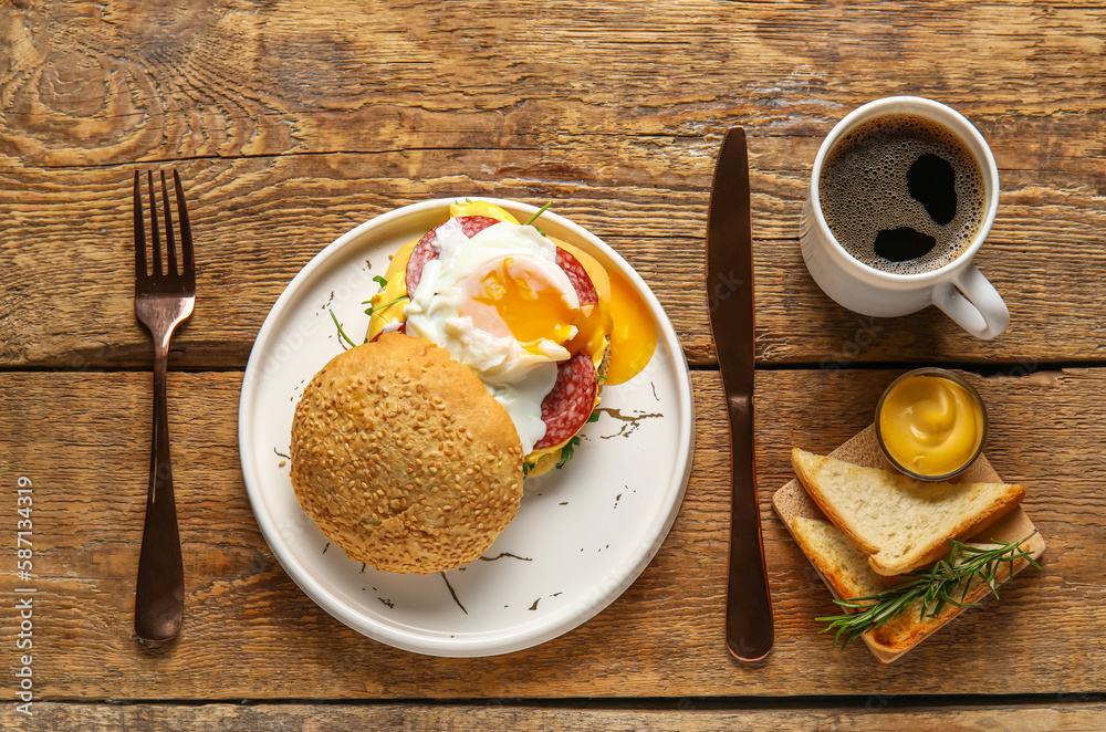 Plate with tasty egg Benedict and cup of coffee on wooden background Plate with tasty egg Benedict and cup of coffee on wooden background