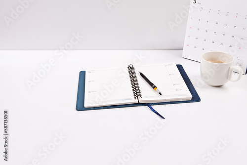 There are coffee cups, pens, diaries, and calendars
