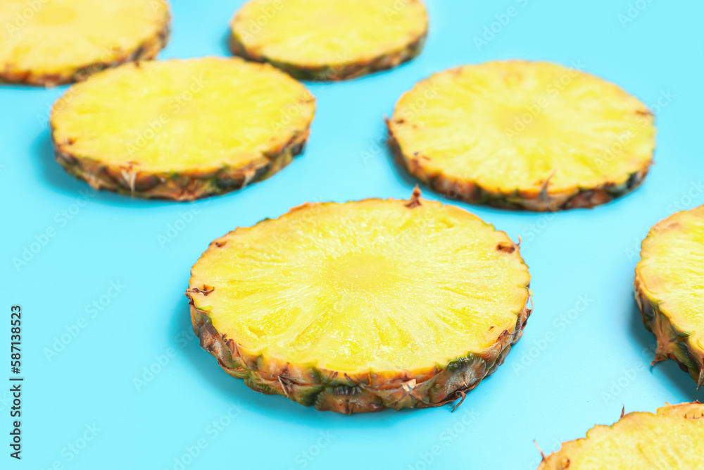 Slices of fresh ripe pineapple on blue background Slices of fresh ripe pineapple on blue background