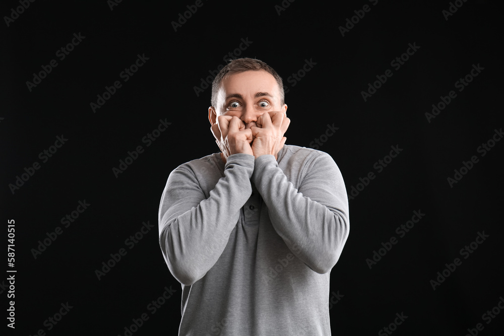 Scared mature man on black background Scared mature man on black background
