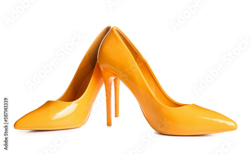 Pair of yellow high heeled shoes on white background