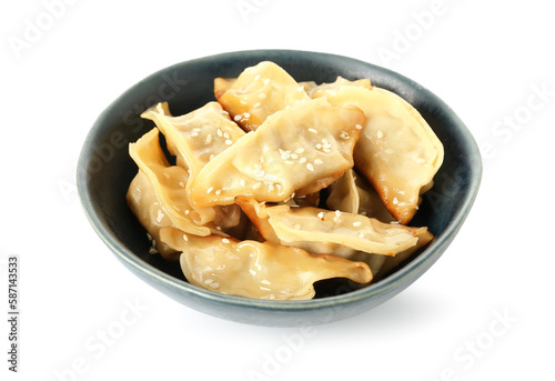 Bowl with tasty Chinese jiaozi and sesame on white background