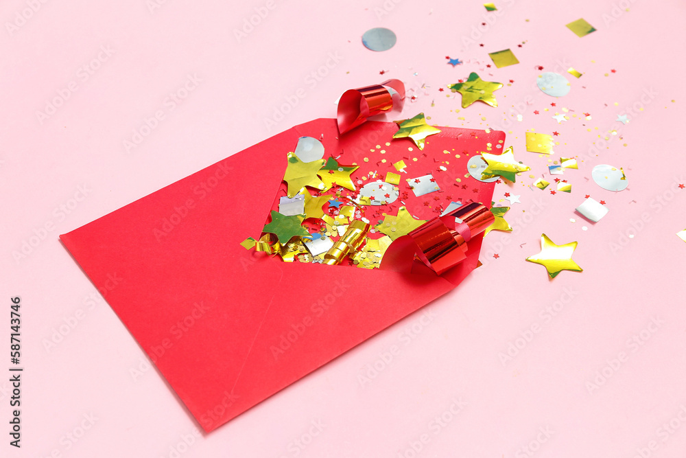 Composition with envelope and confetti on pink background