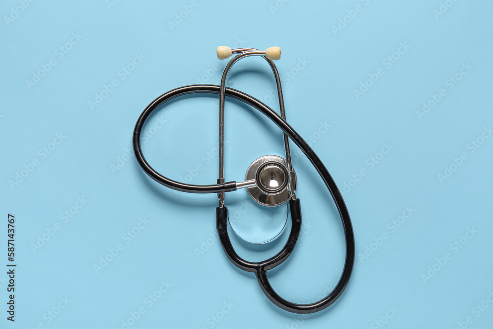 Modern stethoscope on light blue background Modern stethoscope on light blue background