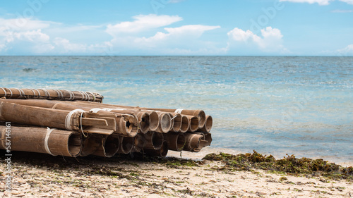 an old bamboo raft on the shore of a tropical island, abandoned photo