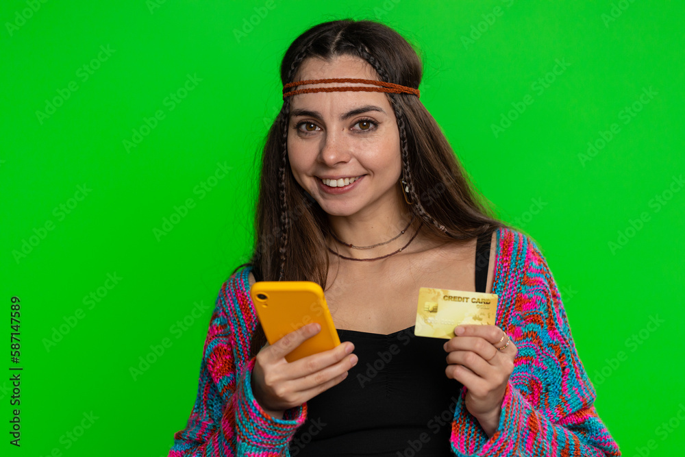 Sincere young woman customer using credit bank card and smartphone while transferring money, purchases online shopping, payment. Finance and internet. Pretty girl isolated on chroma key background Sincere young woman customer using credit bank card and smartphone while transferring money, purchases online shopping, payment. Finance and internet. Pretty girl isolated on chroma key background