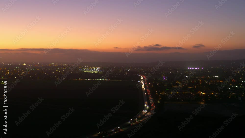 Aerial Panning Shot Of Cars Moving On Illuminated Roads During Sunset - Camarillo, California Aerial Panning Shot Of Cars Moving On Illuminated Roads During Sunset - Camarillo, California