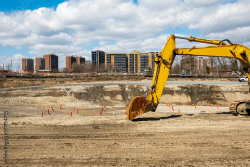 Photography large excavator with bucket shovel parked on site at a large construction projec