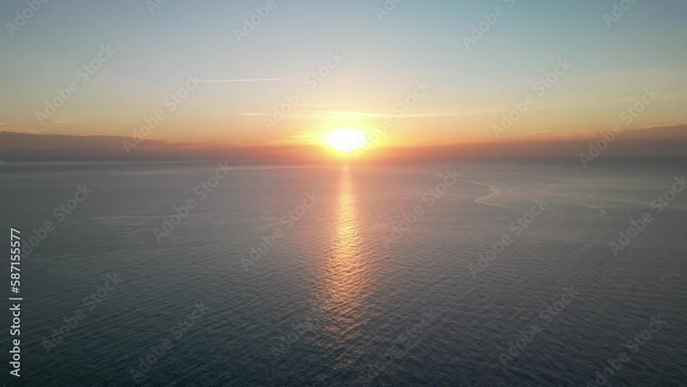 Sunset On The Horizon With Reflection On Idyllic Beach In Mallorca, Spain. Aerial Wide Shot Sunset On The Horizon With Reflection On Idyllic Beach In Mallorca, Spain. Aerial Wide Shot