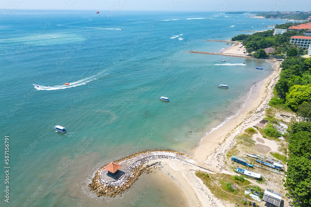 Aerial view of the seashore with hotels and boats in the sea.
