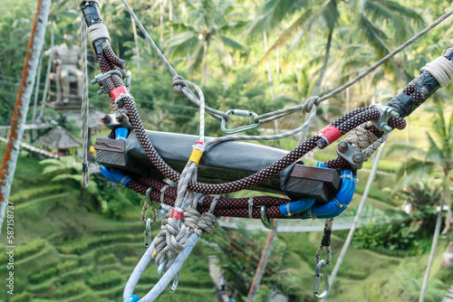 Extreme swing seat with equipment in the background of the jungle. Close-up.