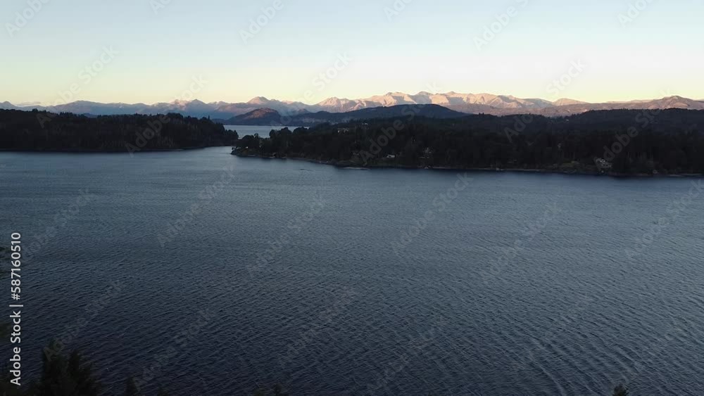 Cinematic aerial reveal of the Nahuel Huapi lake at sunset in Cerveza Patagonia, Bariloche. Cinematic aerial reveal of the Nahuel Huapi lake at sunset in Cerveza Patagonia, Bariloche.