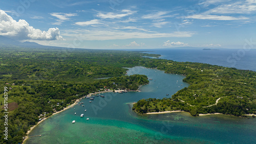 Top view of bay with boats on the background of mountains. Negros, Philippines.