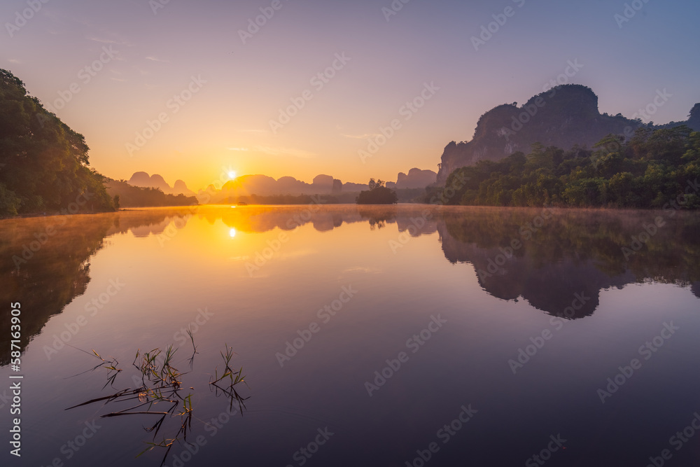 The sunrise over the lake with mountain background and fantastic sky in Krabi Thailand	
