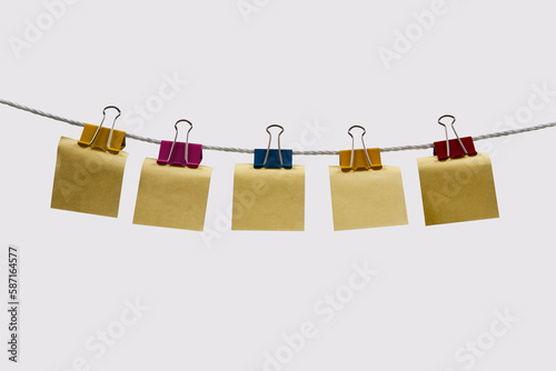 The clothesline is strewn with double clips and notepads