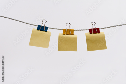 The clothesline is strewn with double clips and notepads