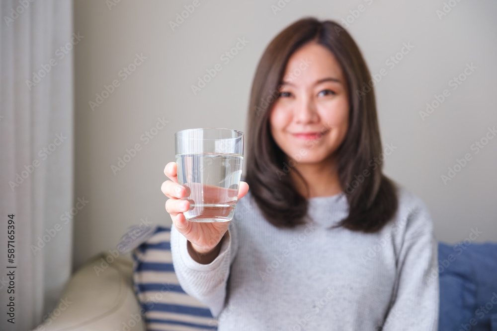 Portrait image of a young woman holding and drinking water Portrait image of a young woman holding and drinking water