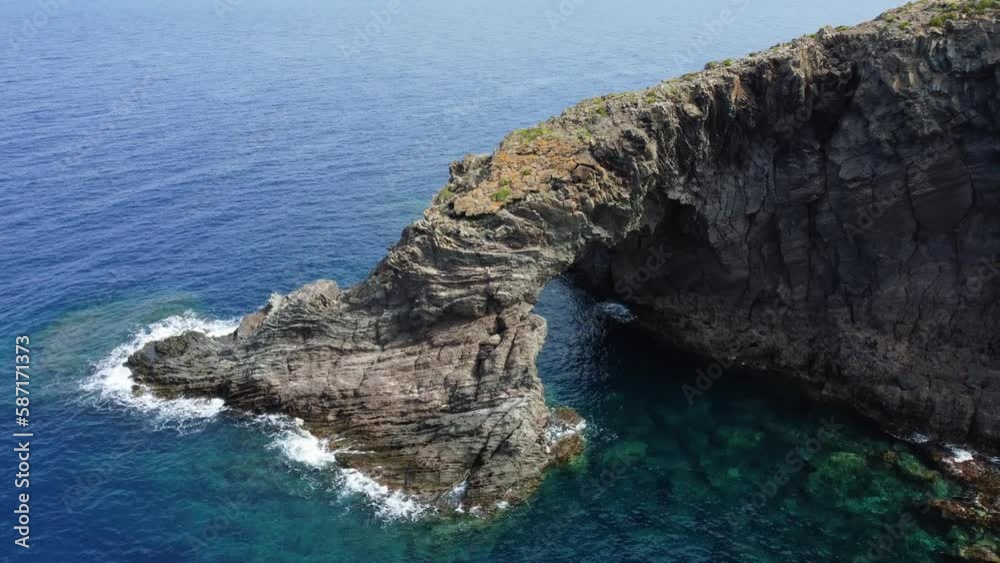 Aerial view around the sunlit Elephant arch rock in Pantelleria island, Italy Aerial view around the sunlit Elephant arch rock in Pantelleria island, Italy
