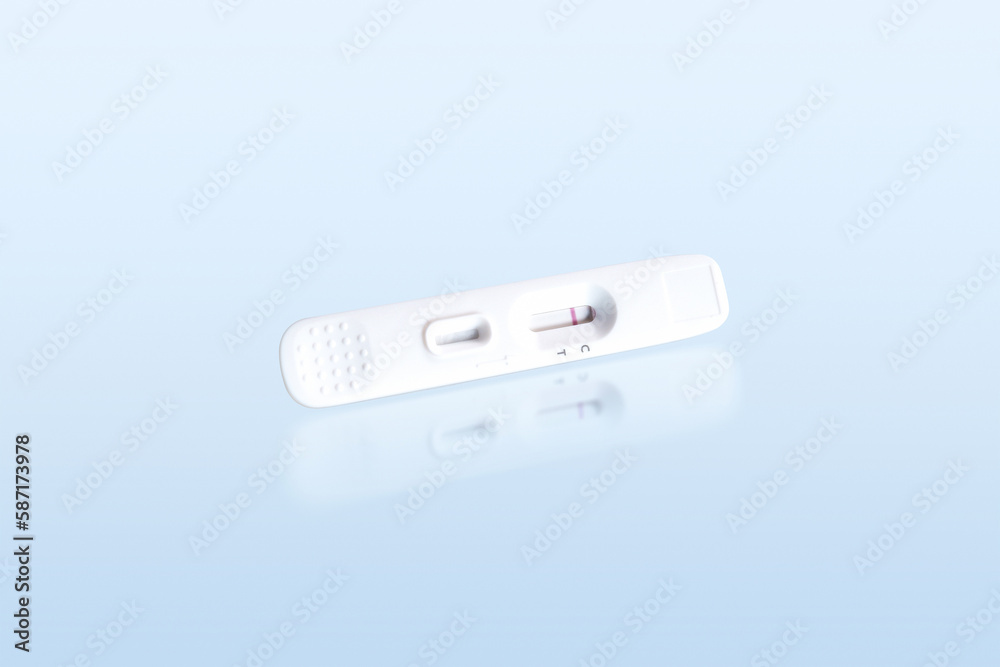 Negative antigen test of antigen test cassette isolated on blue background with reflection, Medical instrument concept, clipping path included.