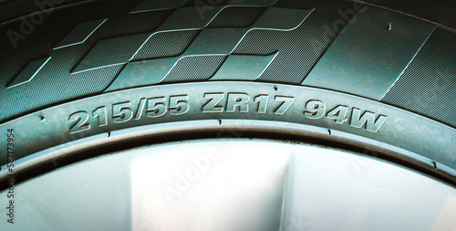 Numbers and characters on the sidewall of a car tire, automotive parts concept. photo