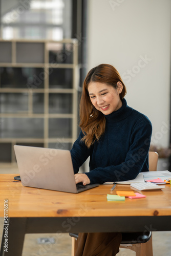 Young Asian businesswoman holding notebook about business, spending money