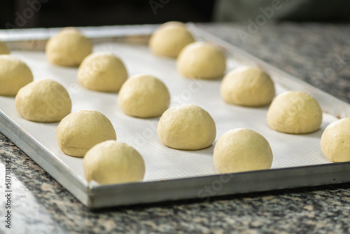 Balls of Dough Placed On a Cooking Paper in a Baking Pan