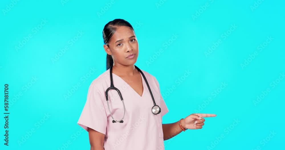 Woman, doctor and point in studio for mockup, healthcare decision or tips menu by blue background. Young female medic, pointing or portrait for disagree, mock up space or advice for bad health habits Woman, doctor and point in studio for mockup, healthcare decision or tips menu by blue background. Young female medic, pointing or portrait for disagree, mock up space or advice for bad health habits