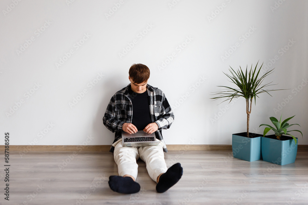man spends time at the laptop at home studying and working man spends time at the laptop at home studying and working