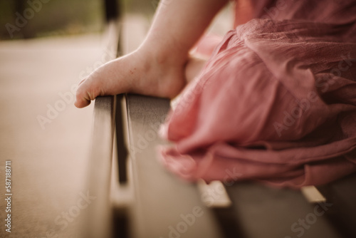 side view of young girl s foot  wearing pink dress