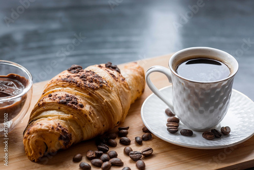 Delicious freshly baked croissants with chocolate and coffee on a dark background. French breakfast. Delicious pastries close-up. The context of a bakery with delicious bread. Confectionery products.