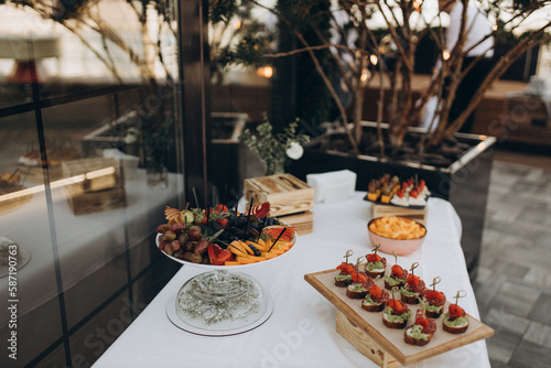 table setting for dinner with fruit on the summer terrace
