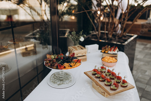 table setting for dinner with fruit on the summer terrace