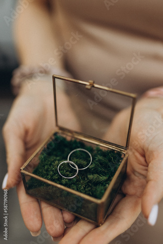 girl's hands holding engagement rings