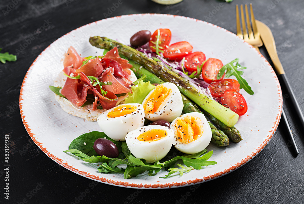 Keto breakfast. Fried asparagus with boiled eggs and toast with prosciutto or jamon. Ketogenic diet. Healthy food. Keto breakfast. Fried asparagus with boiled eggs and toast with prosciutto or jamon. Ketogenic diet. Healthy food.