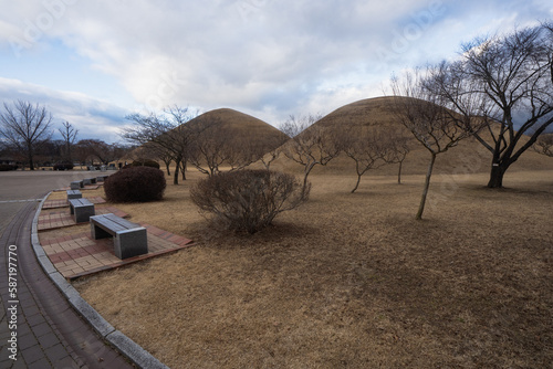 Daereungwon Tomb Complex and Cheonmachong Hwangnam Daechong during winter evening at Gyeongju , South Korea : 10 February 2023 photo