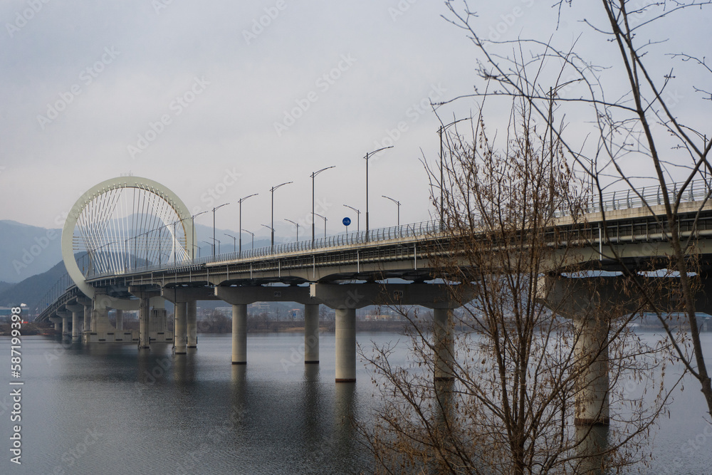 Chuncheon bridge over Soyang river with mountain and city view during winter afternoon at Chuncheon , South Korea : 11 February 2023