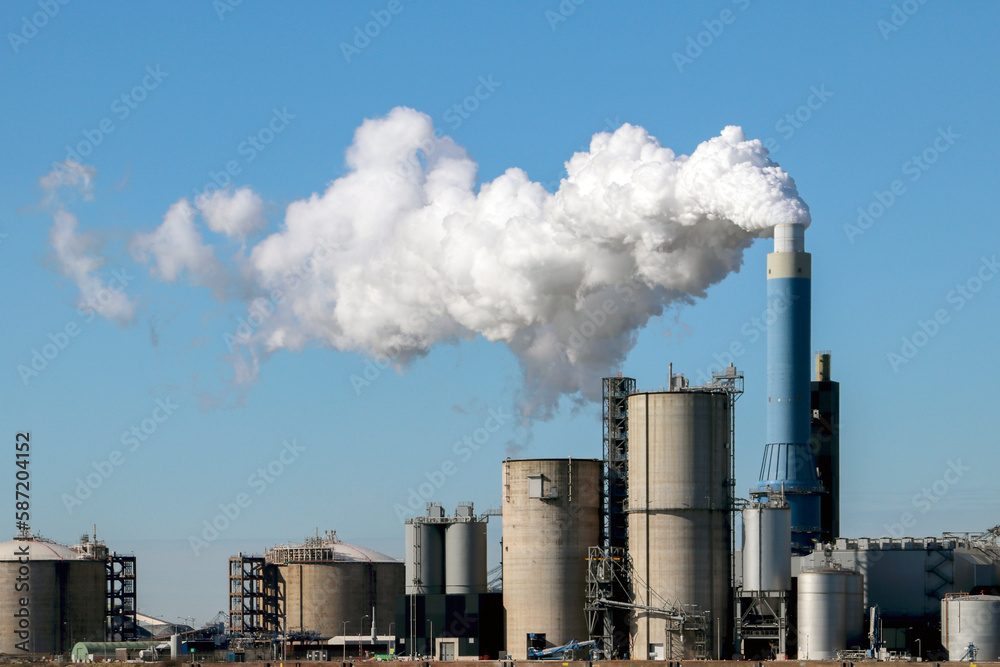 Steam coming out of the chimney at power plant in Rotterdam Maasvlakte in Netherlands Steam coming out of the chimney at power plant in Rotterdam Maasvlakte in Netherlands