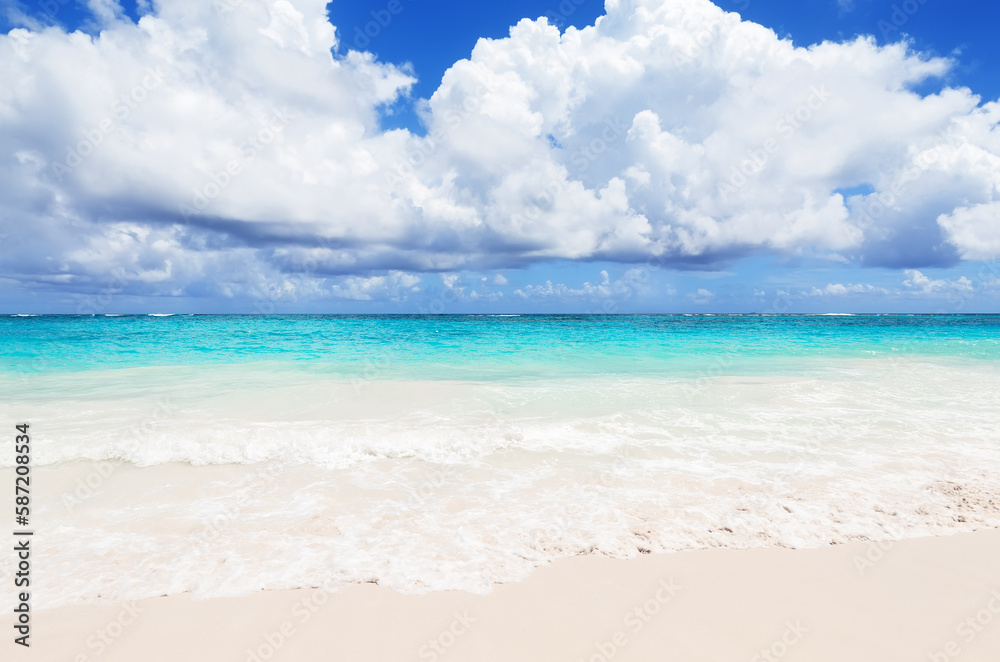 Landscape view of beautiful tropical white sand beach and turquoise sea in sunny day in Punta Cana, Dominican Republic. Landscape view of beautiful tropical white sand beach and turquoise sea in sunny day in Punta Cana, Dominican Republic.