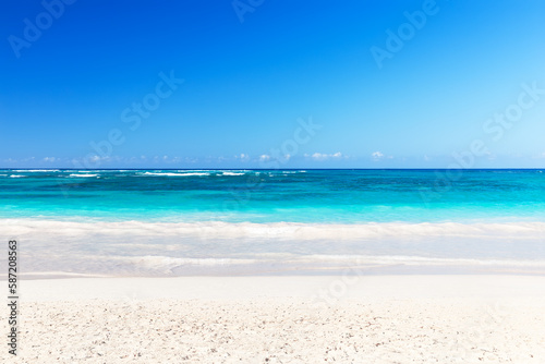 Fototapeta Naklejka Na Ścianę i Meble -  Landscape view of beautiful tropical white sand beach and turquoise sea in sunny day in Punta Cana, Dominican Republic.